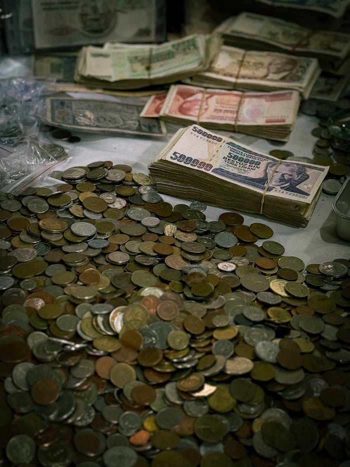 A collection of old coins and banknotes, highlighting vintage currency.
